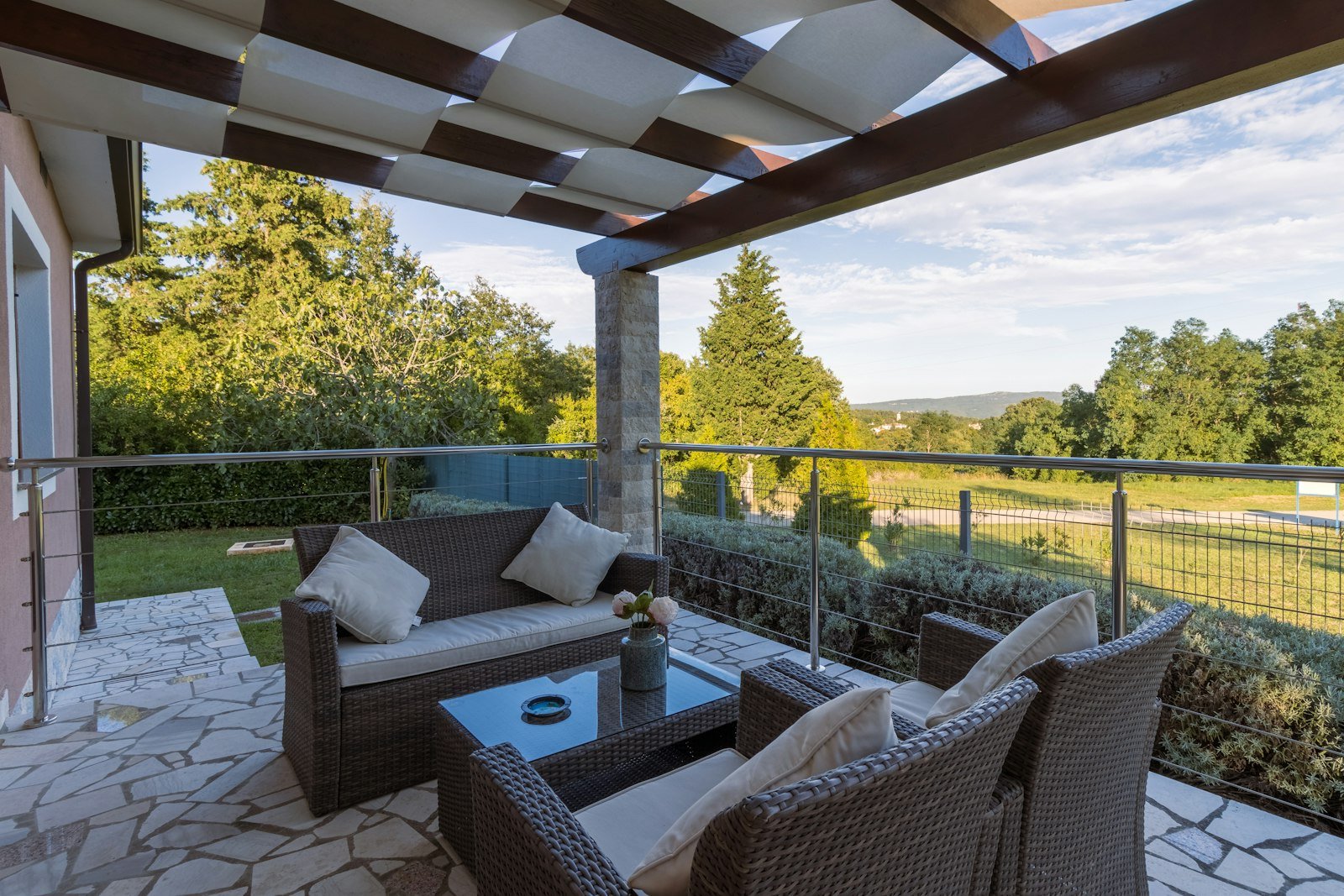 Covered patio with lounge seating over a concrete slab