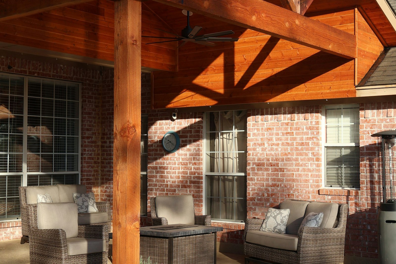 Timber-framed covered porch attached to a brick house