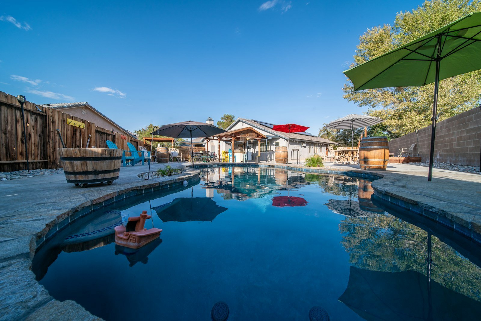 Pool deck with loungers and a covered structure behind