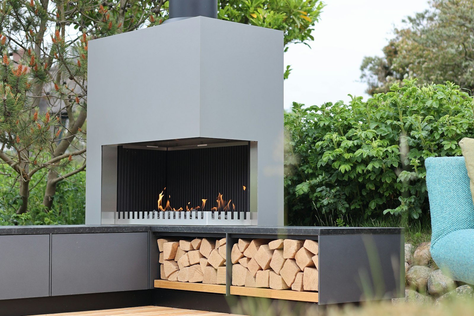 Outdoor fireplace with a firebox and stacked wood storage