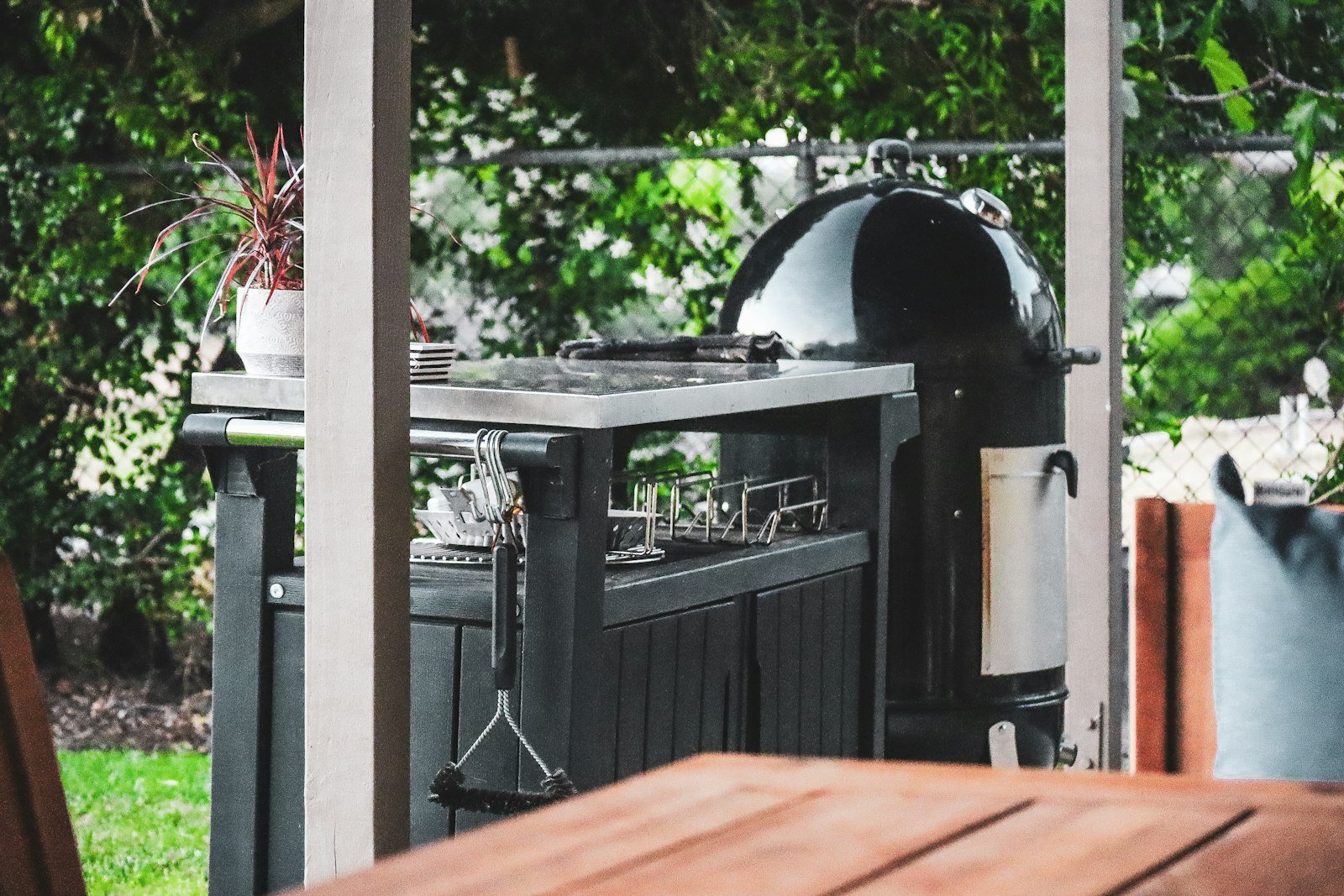 Outdoor kitchen island beneath a pergola