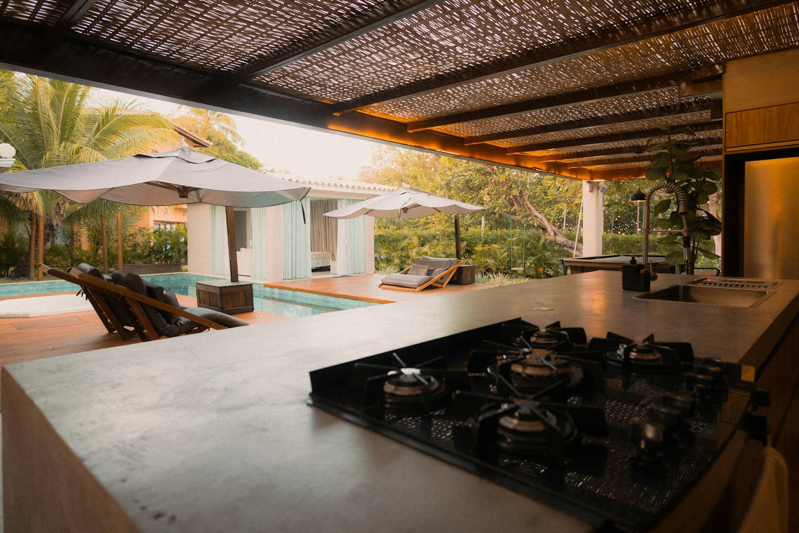 Modern covered outdoor living space with a cook station