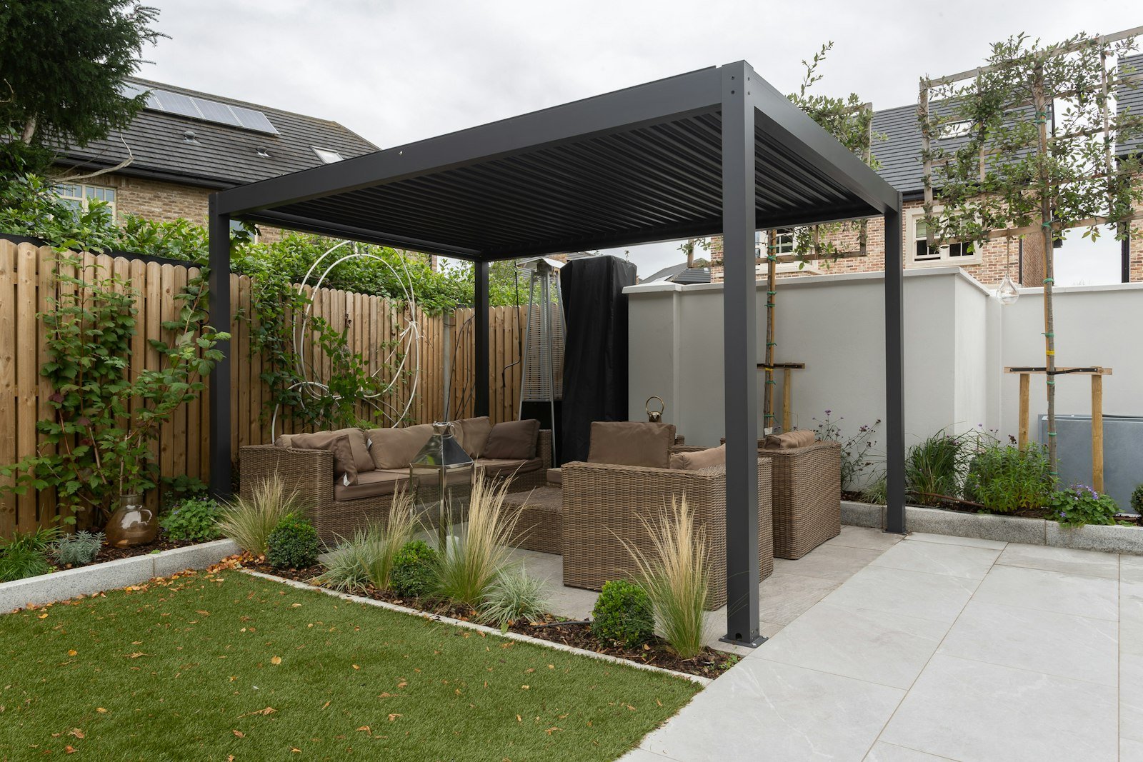 Modern dark-framed pergola over a seating area